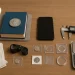 A complete beginner’s toolkit — lighting, gloves, loupe, storage, caliper, scale, reference book, and smartphone — is neatly arranged on a desk to illustrate the essential gear used in everyday coin inspection.